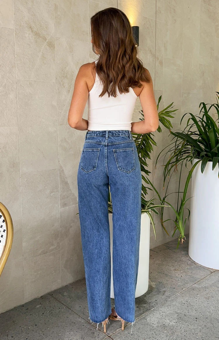 Slanted waist crossover jeans with straight leg and frayed hem